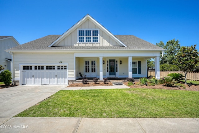 4450 Old Towne St, Wilmington, NC 28412 - view of front of property with board and batten siding, covered porch, an attached garage, driveway, and a shingled roof