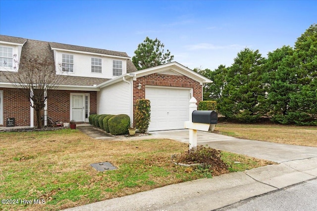 view of front of home featuring a garage and a front lawn