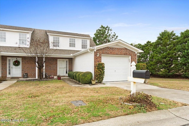 view of front of property featuring a garage and a front yard