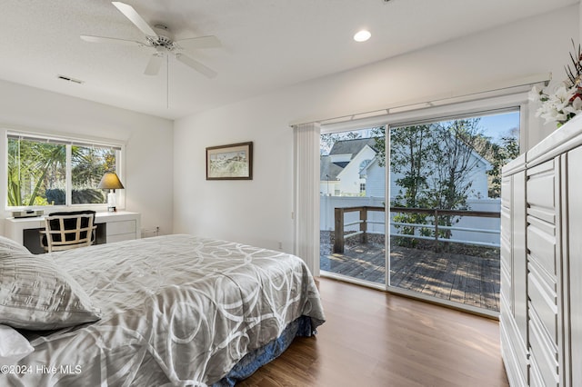 bedroom featuring access to outside, ceiling fan, and dark hardwood / wood-style flooring