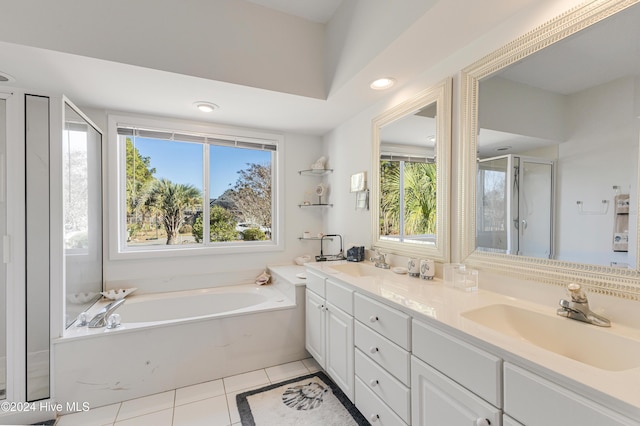 bathroom with tile patterned floors, vanity, and plus walk in shower