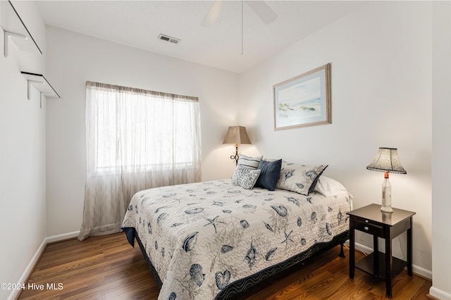 bedroom featuring ceiling fan and dark wood-type flooring