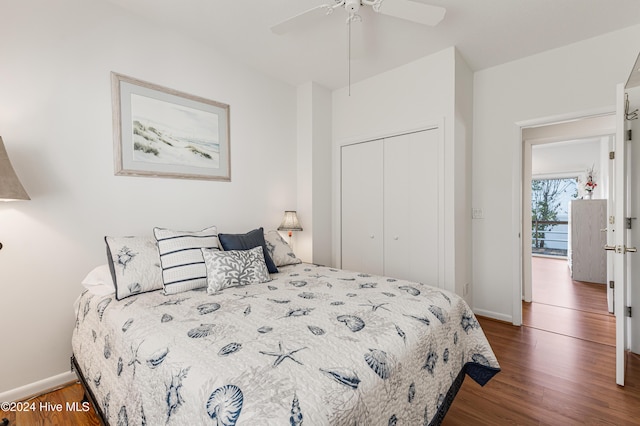 bedroom featuring dark hardwood / wood-style floors, a closet, and ceiling fan