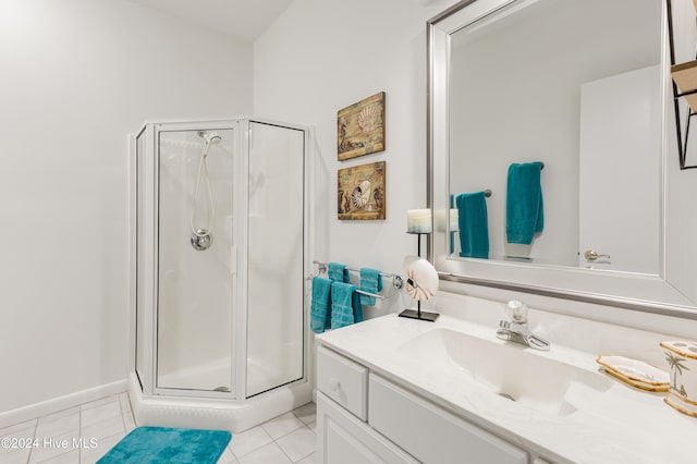 bathroom featuring tile patterned flooring, vanity, and a shower with shower door