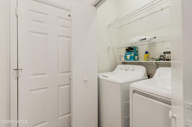 laundry room featuring washing machine and clothes dryer