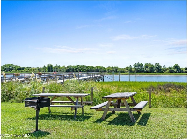 view of home's community featuring a water view and a boat dock