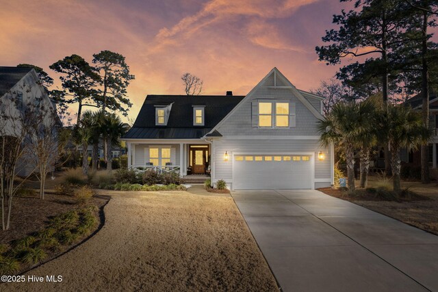 view of front of property featuring covered porch and a garage