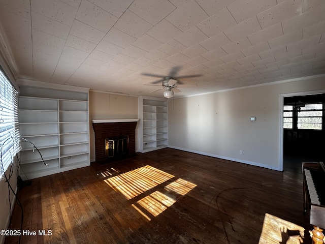 unfurnished living room with a fireplace, crown molding, built in features, and dark hardwood / wood-style flooring