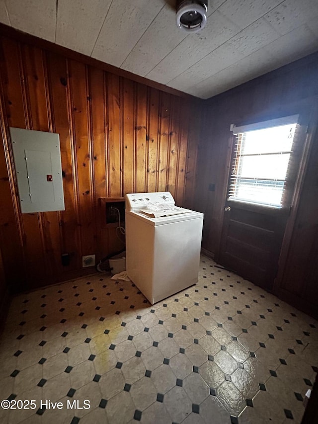 washroom featuring electric panel, washer / dryer, and wooden walls