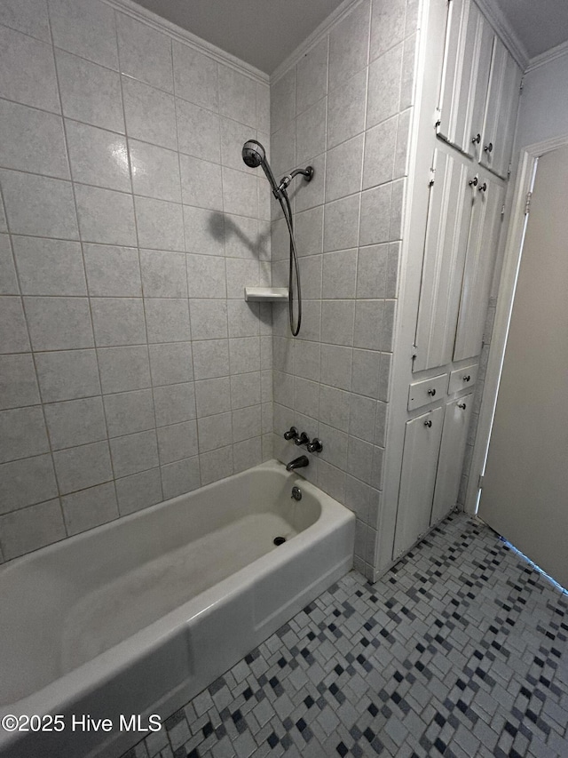 bathroom with tile patterned floors, tiled shower / bath, and crown molding