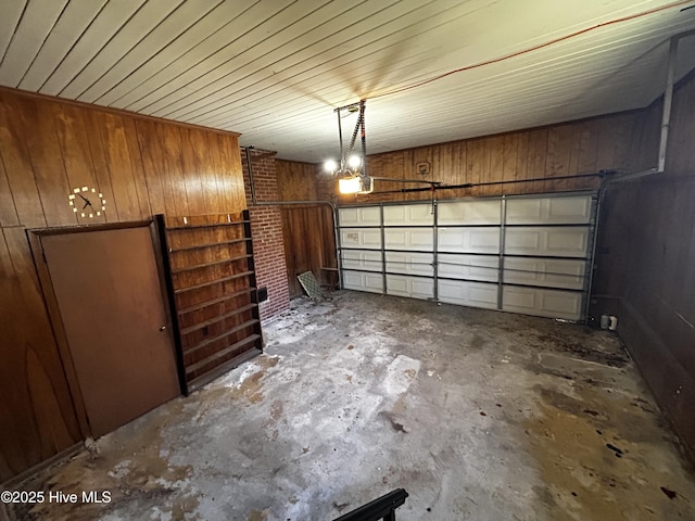 garage with wood walls and a garage door opener