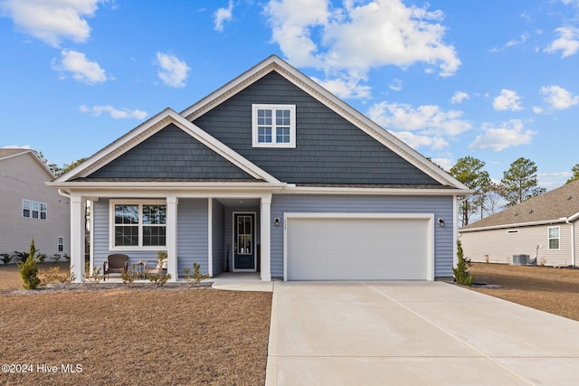 view of front of property featuring central AC unit and a garage