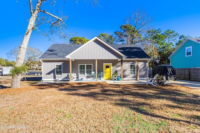 rear view of house featuring a porch