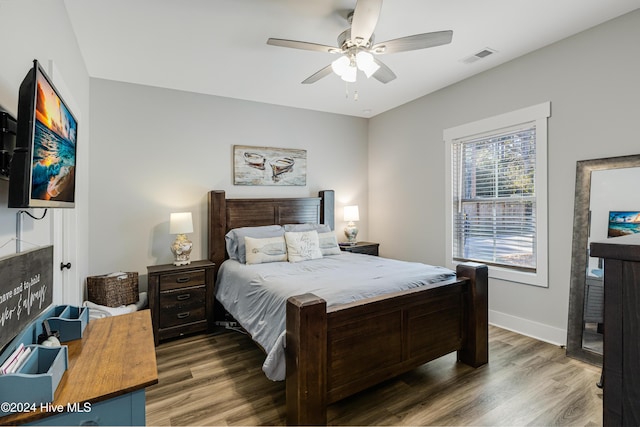 bedroom with ceiling fan and dark hardwood / wood-style floors