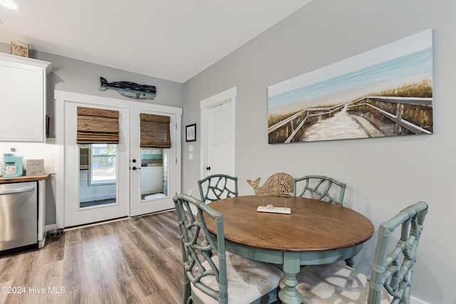 dining room with french doors and hardwood / wood-style flooring