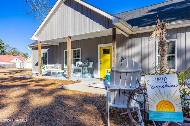 rear view of property featuring a porch