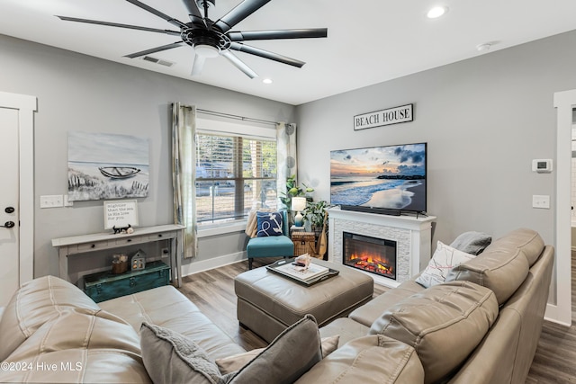 living room with ceiling fan and wood-type flooring