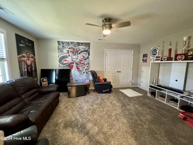 living room with carpet, a textured ceiling, and ceiling fan