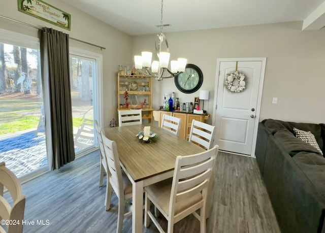 dining area featuring a chandelier and dark hardwood / wood-style floors