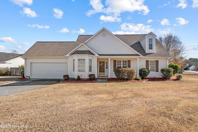 view of front of home with a garage and a front lawn