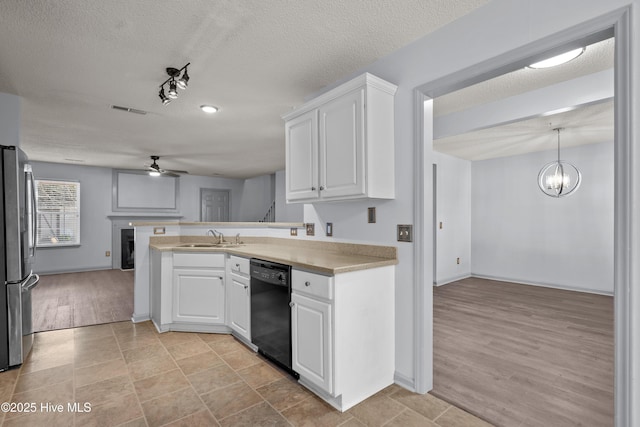 kitchen featuring white cabinets, pendant lighting, stainless steel refrigerator, and dishwasher