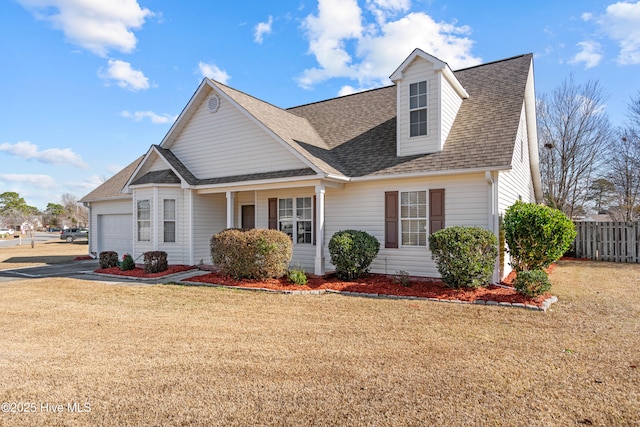 view of front of house featuring a garage and a front lawn