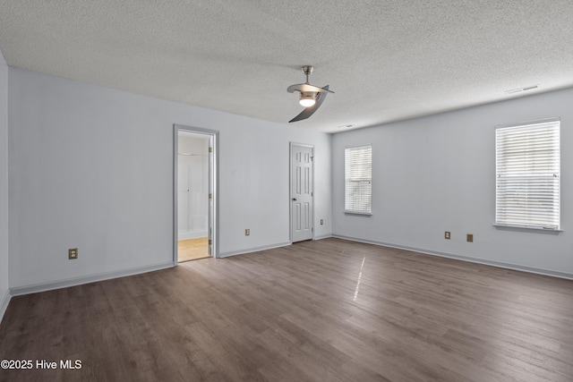 empty room with ceiling fan, a textured ceiling, and hardwood / wood-style flooring