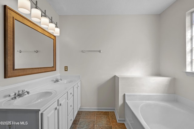 bathroom with vanity and a tub