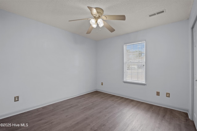 empty room with hardwood / wood-style flooring, ceiling fan, and a textured ceiling