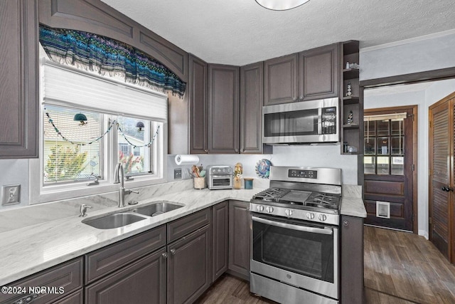 kitchen with a textured ceiling, dark hardwood / wood-style floors, sink, and stainless steel appliances