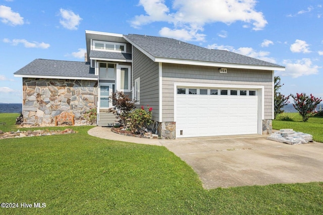 view of front of house with a garage and a front lawn