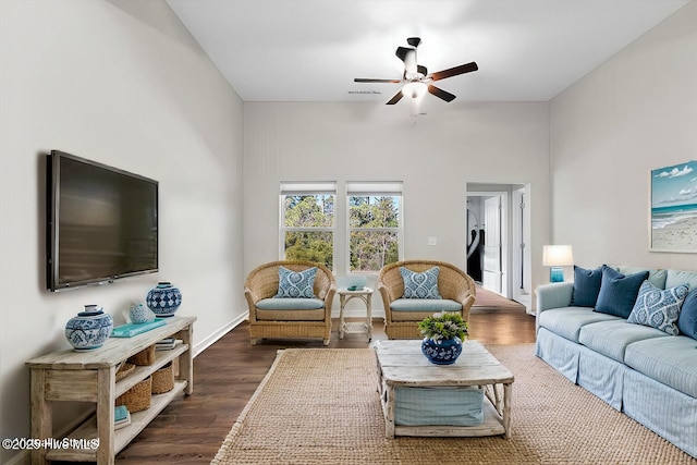 living room featuring dark hardwood / wood-style flooring and ceiling fan