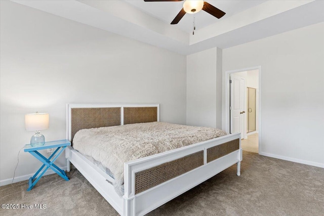 bedroom featuring ceiling fan, a raised ceiling, and carpet floors