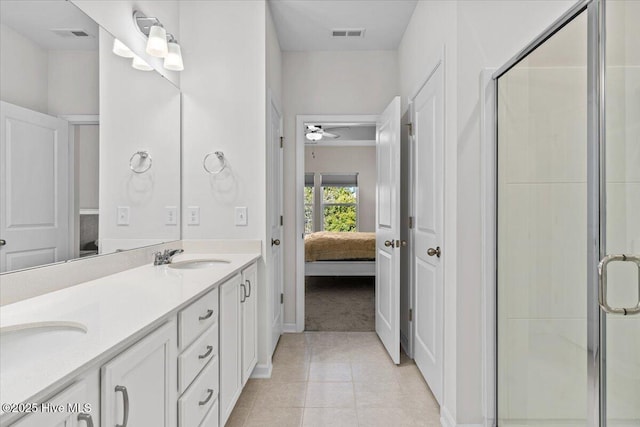 bathroom with tile patterned flooring, vanity, a shower with door, and ceiling fan