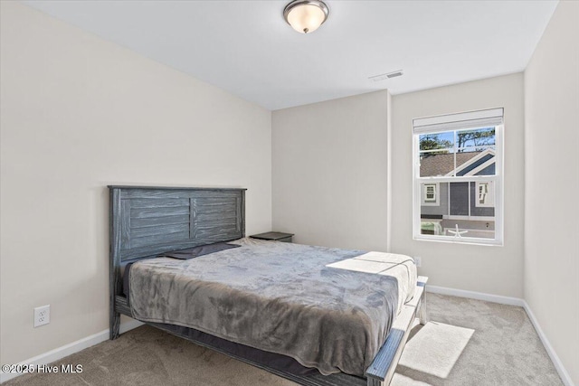 bedroom featuring light carpet