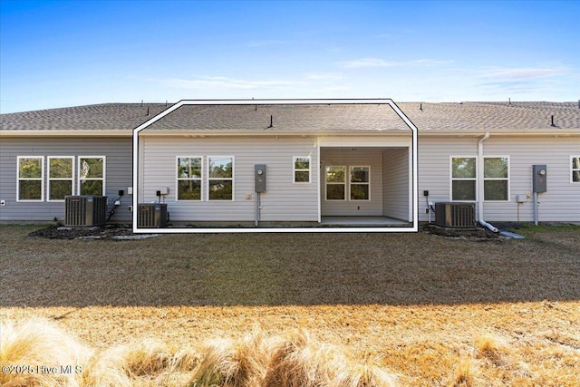 back of property featuring a yard and cooling unit