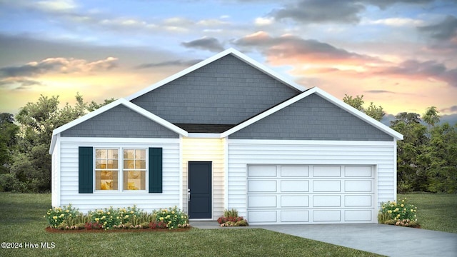 view of front of house with a garage and a lawn