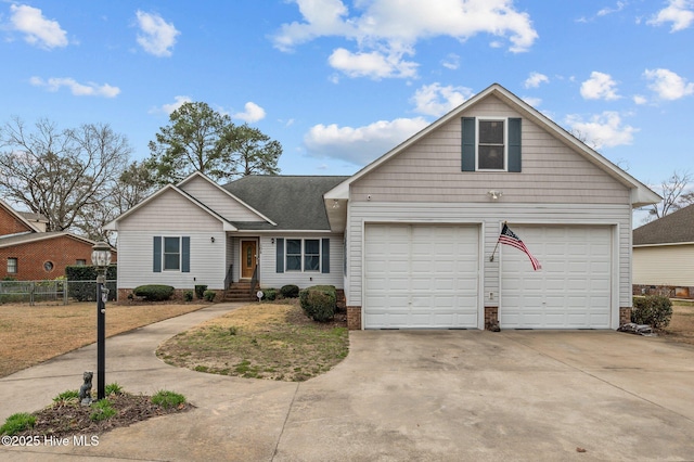 view of front of home featuring fence, a garage, and driveway