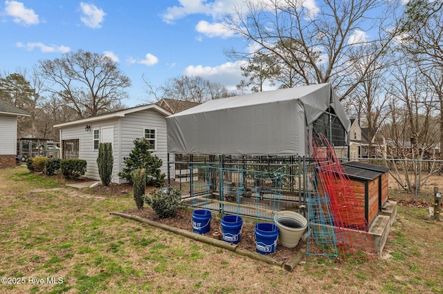 view of property exterior featuring a yard and an outbuilding