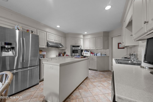 kitchen with under cabinet range hood, a sink, stainless steel appliances, light countertops, and light tile patterned floors