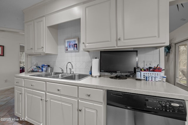 kitchen featuring white cabinetry, a sink, decorative backsplash, light countertops, and dishwasher