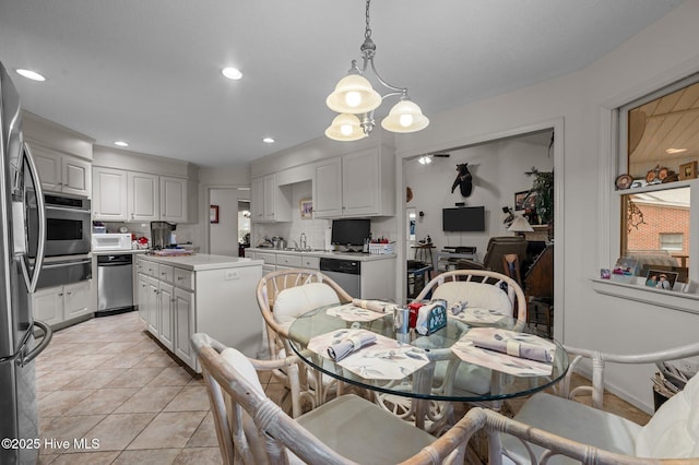 dining area with light tile patterned flooring and recessed lighting