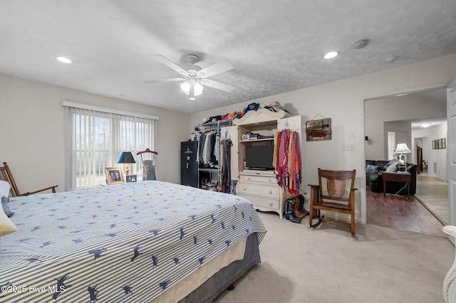 bedroom with light carpet, recessed lighting, a closet, and ceiling fan