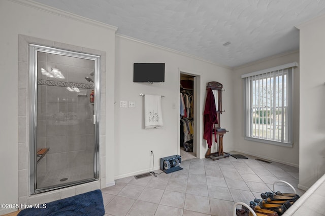 foyer featuring crown molding, light tile patterned flooring, baseboards, and visible vents