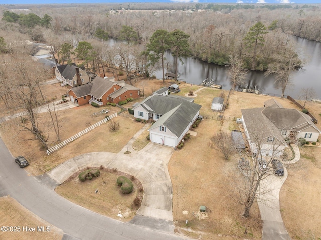 drone / aerial view featuring a forest view and a water view