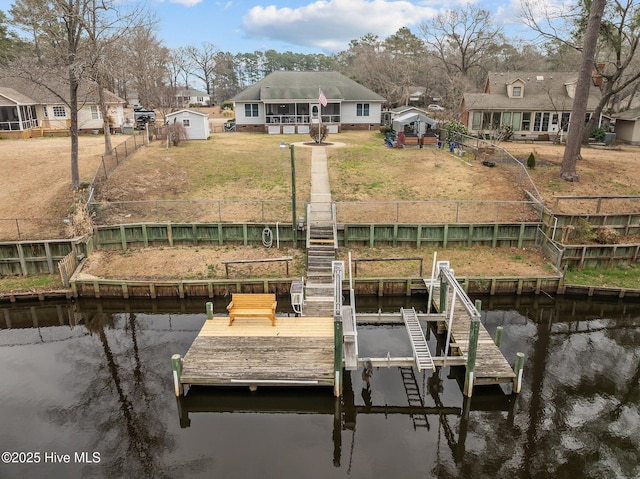 dock area featuring fence, a yard, stairs, a water view, and a residential view