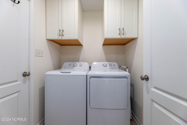 laundry room with cabinets and washing machine and dryer