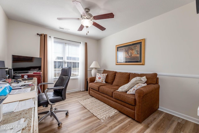 home office featuring ceiling fan and light hardwood / wood-style flooring