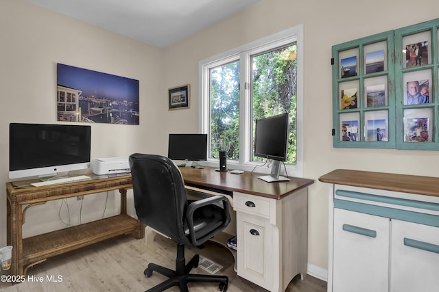 office space with wood finished floors and baseboards