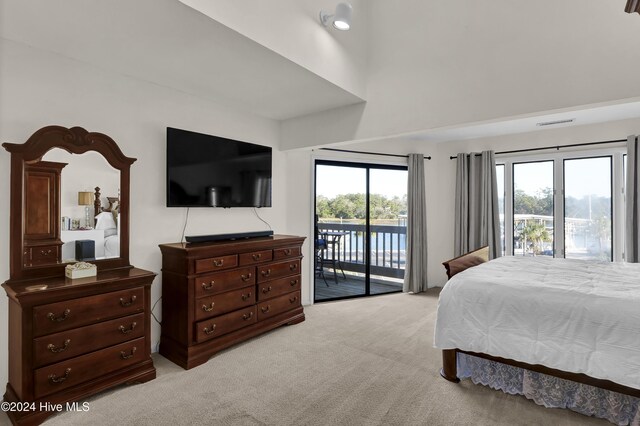 bedroom with visible vents, multiple windows, light colored carpet, and access to outside